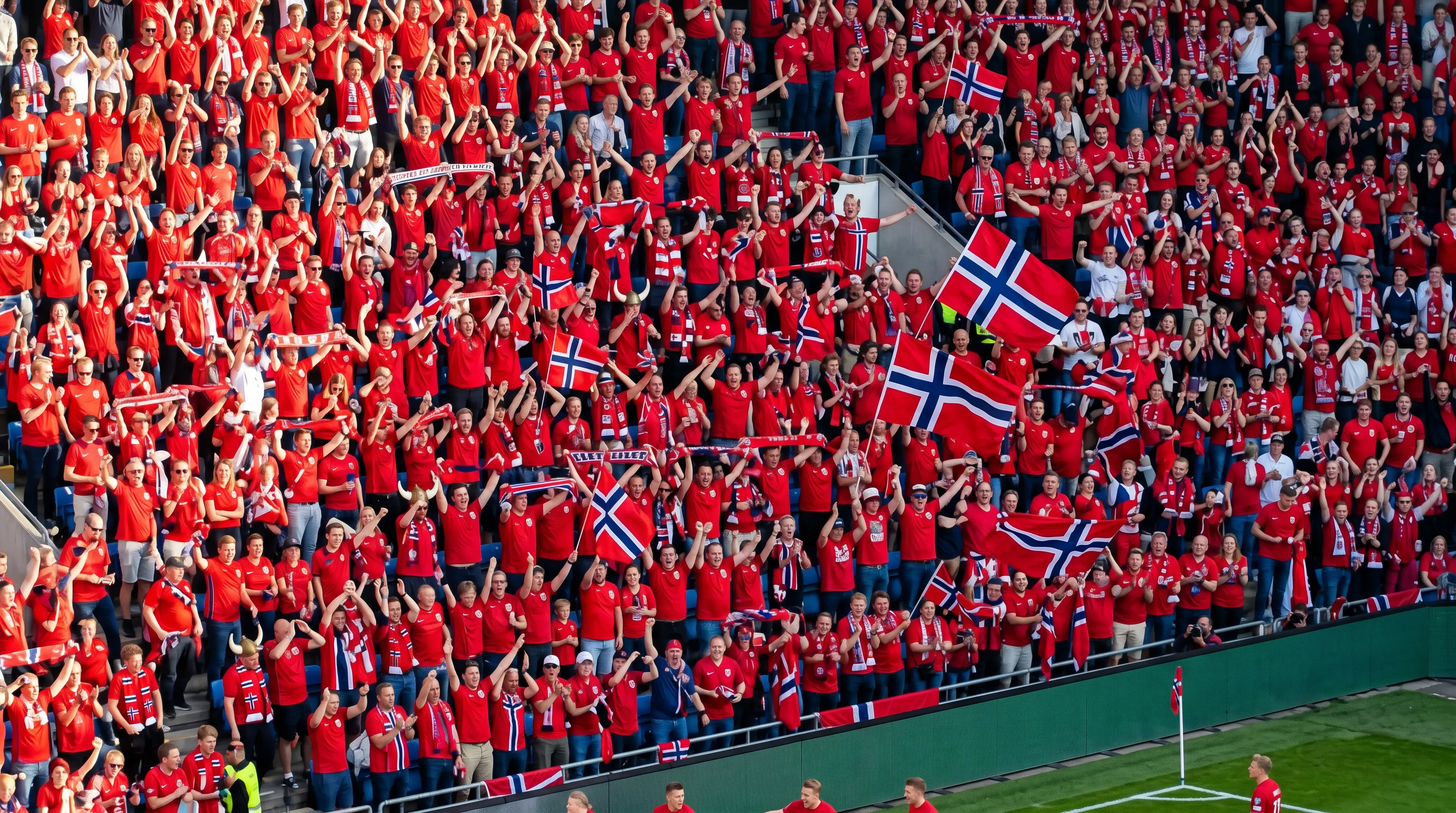 Aerial view of a packed stadium of Norway football fans in red jerseys waving the red-white-blue Nordic-cross flag during a World Cup match.
